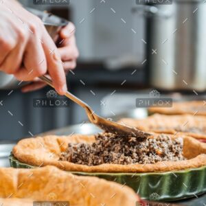 demo-attachment-373-hands-of-cheif-cook-cooking-and-putting-filling-PESKNNF
