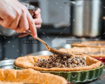 demo-attachment-373-hands-of-cheif-cook-cooking-and-putting-filling-PESKNNF